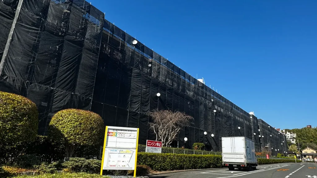 Overall site view of a residential building surrounded by facade scaffolding, showing site conditions that should be assessed before preparing scaffold CAD drawings.
