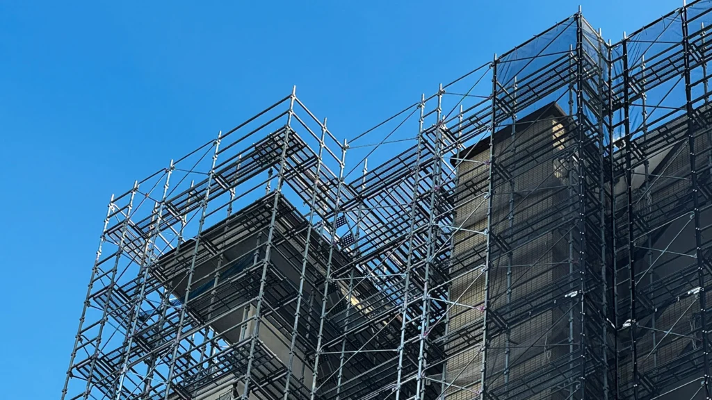 Scaffolding around a multi-level building showing changing platform levels and complex scaffold-to-building interfaces.