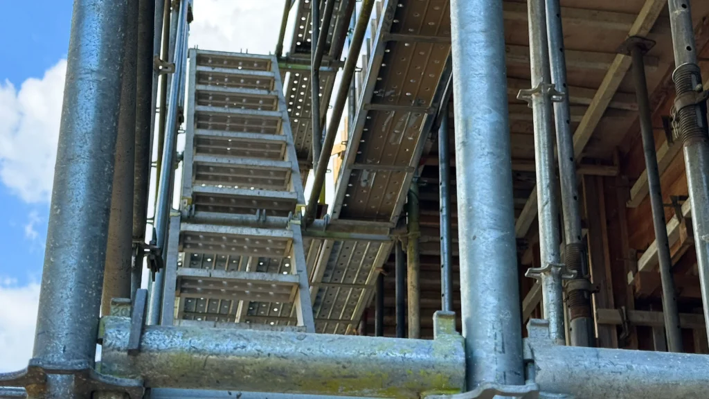 Scaffold dimensions viewed from below, showing vertical standards, working platforms and stair access between scaffold levels.