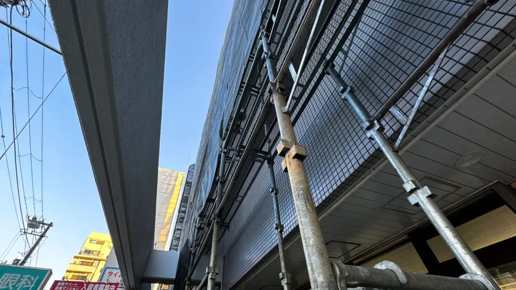 External scaffold installed along a building facade, showing standards, platforms and scaffold-to-building connections in real site conditions.