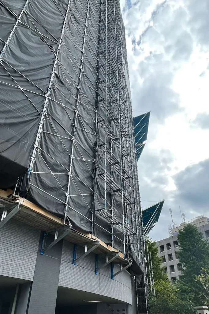 Real cantilever scaffold supported from a building facade with projecting brackets beneath the working platform