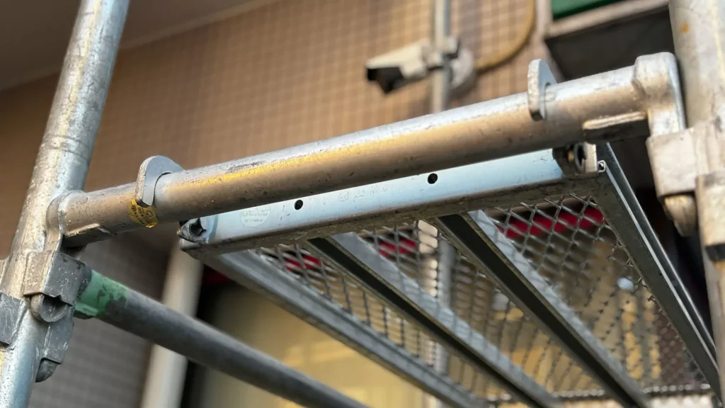 Close-up of scaffold component connections and metal working platform