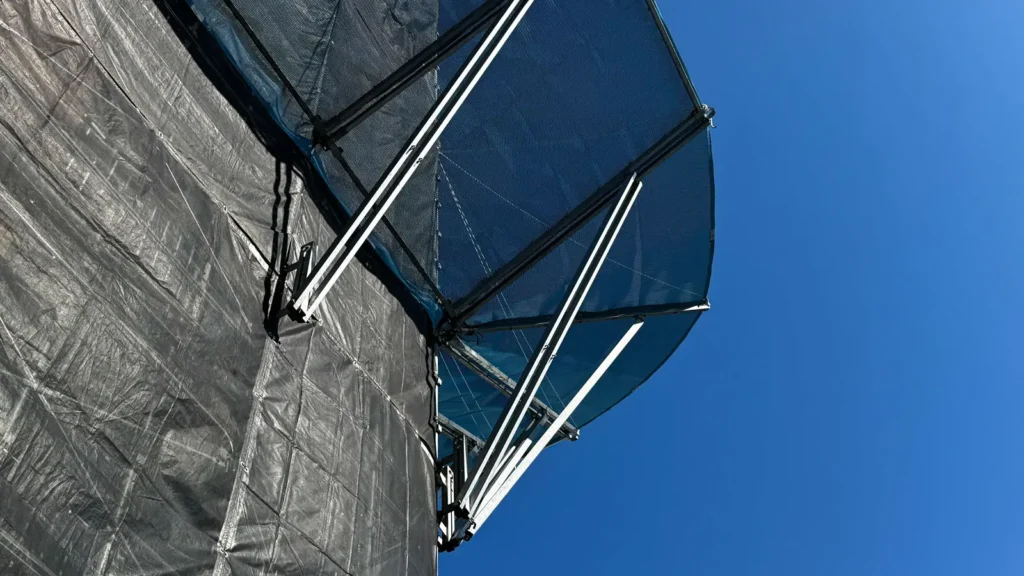 Protective scaffold canopy projecting from a sheeted scaffold showing a special detail to review before drawing issue