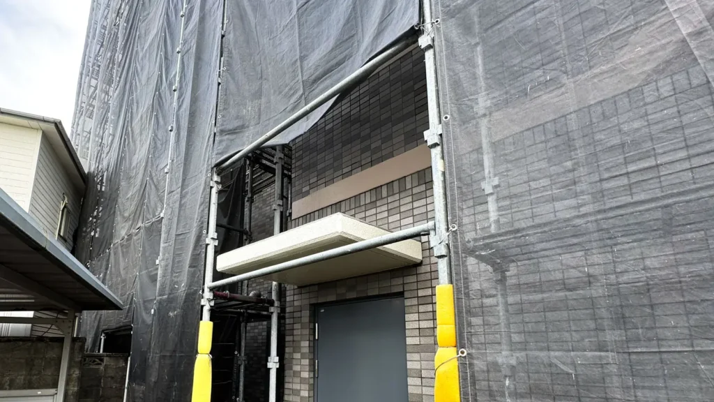 Scaffolding planned around a projecting entrance canopy on an existing building