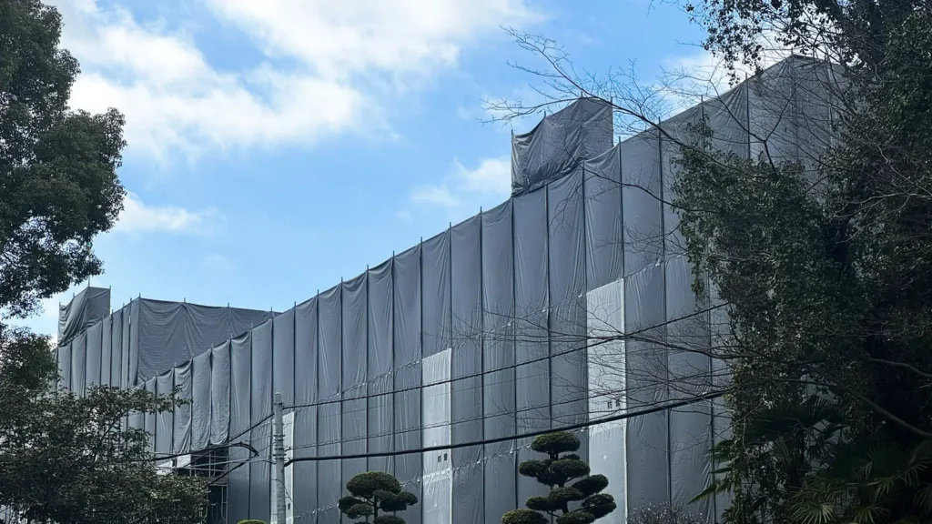 Scaffold covered with sheeting on a building exterior