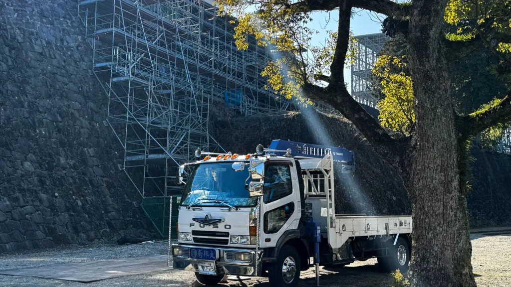Truck beside scaffolding illustrating site access and delivery considerations