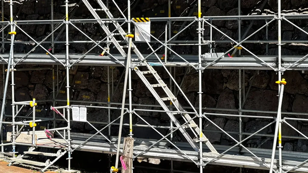 Scaffold stairs connecting multiple working platform levels on a construction scaffold