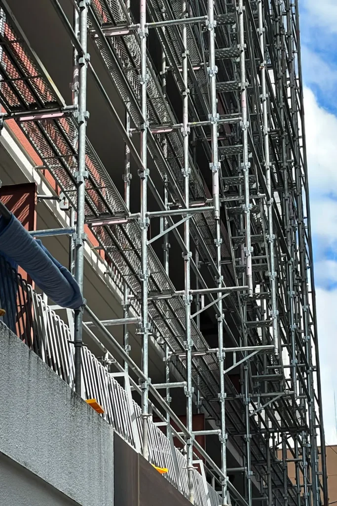 Scaffolding installed around multi-level balconies showing platform and building projection relationships