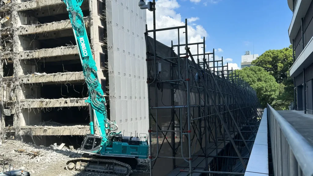 Sheeted scaffold beside a building during demolition work